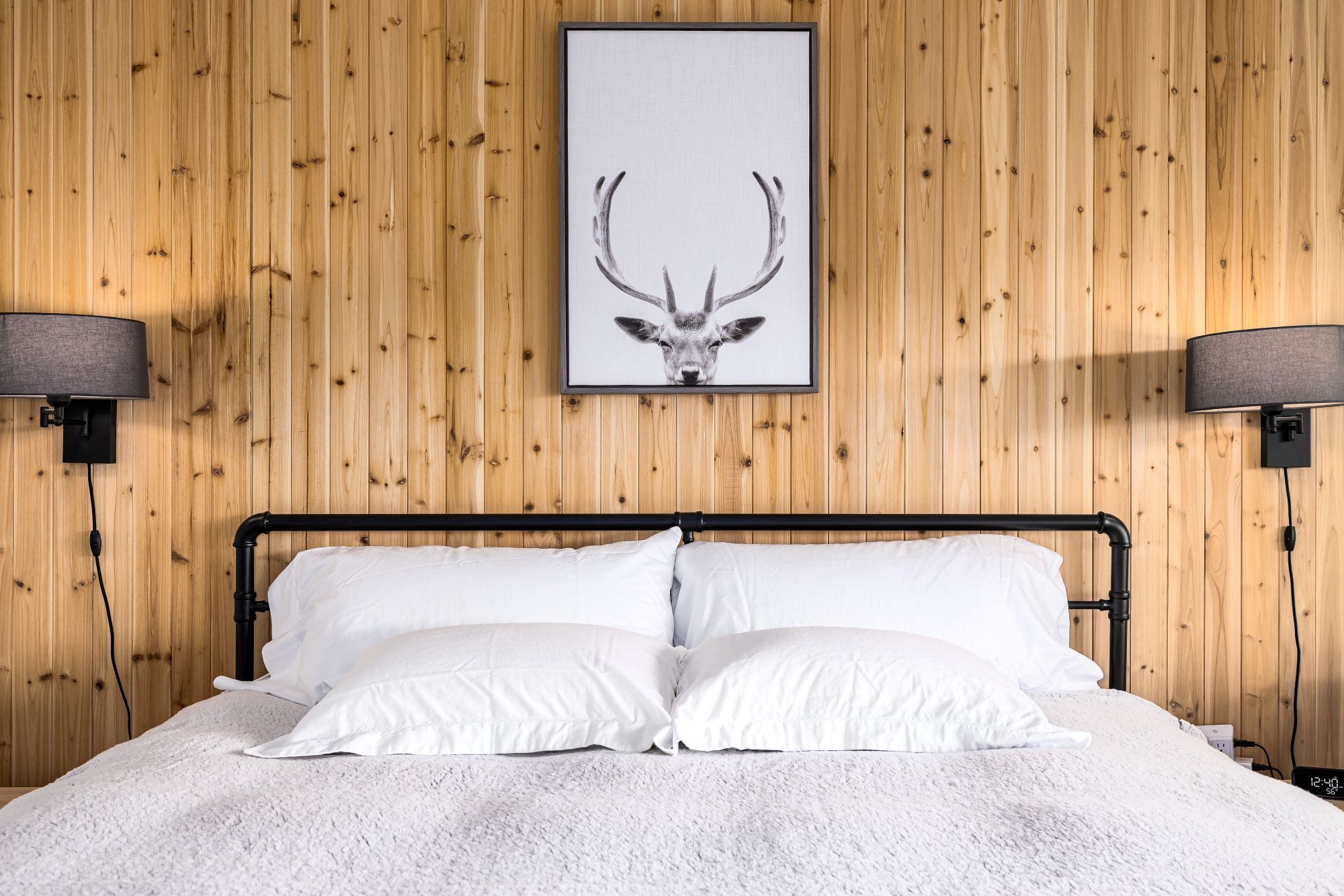 Cozy bedroom with a cedar accent wall and a valley view