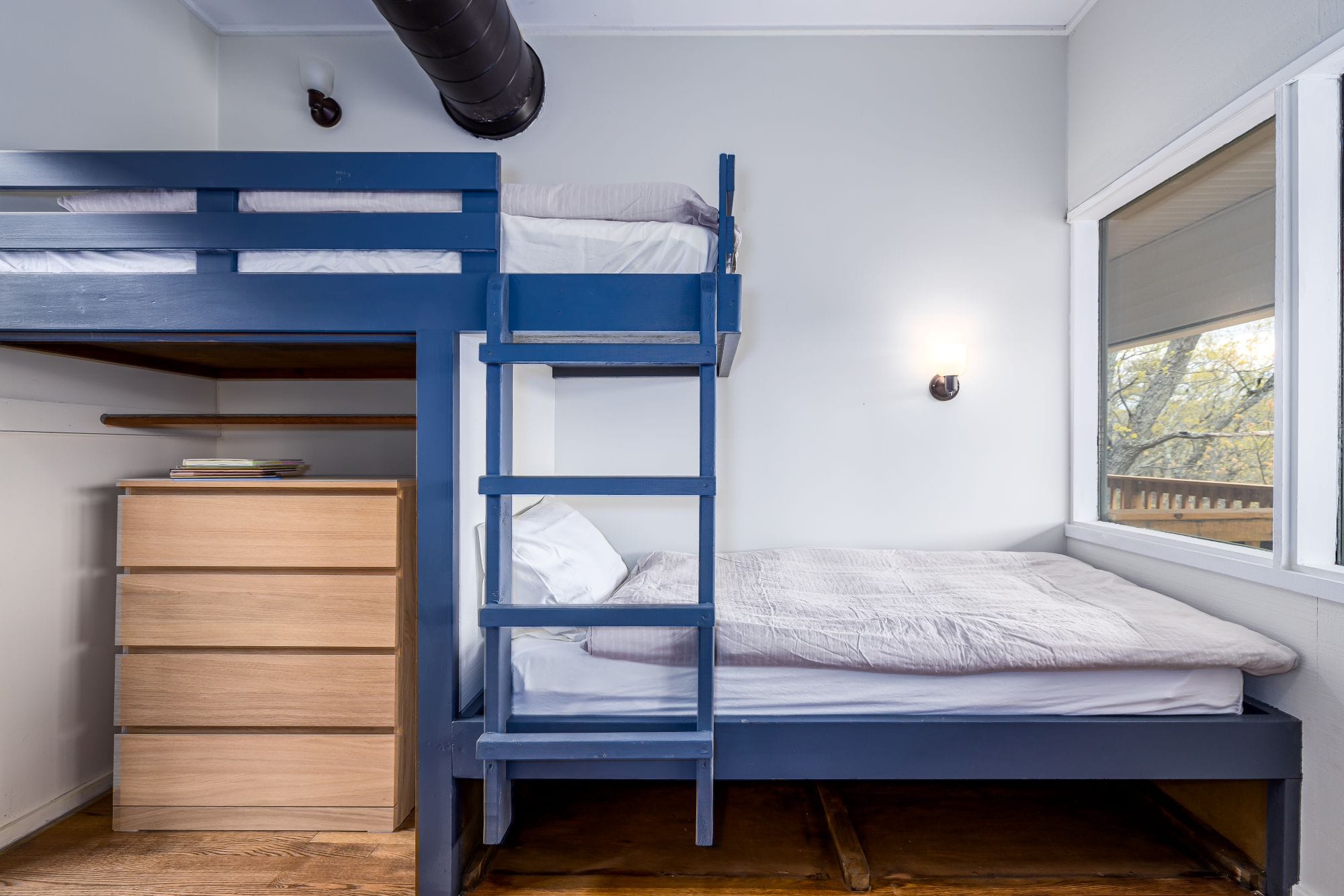 Bunk room with a full-over-full bunk and an extra bed for kids and groups