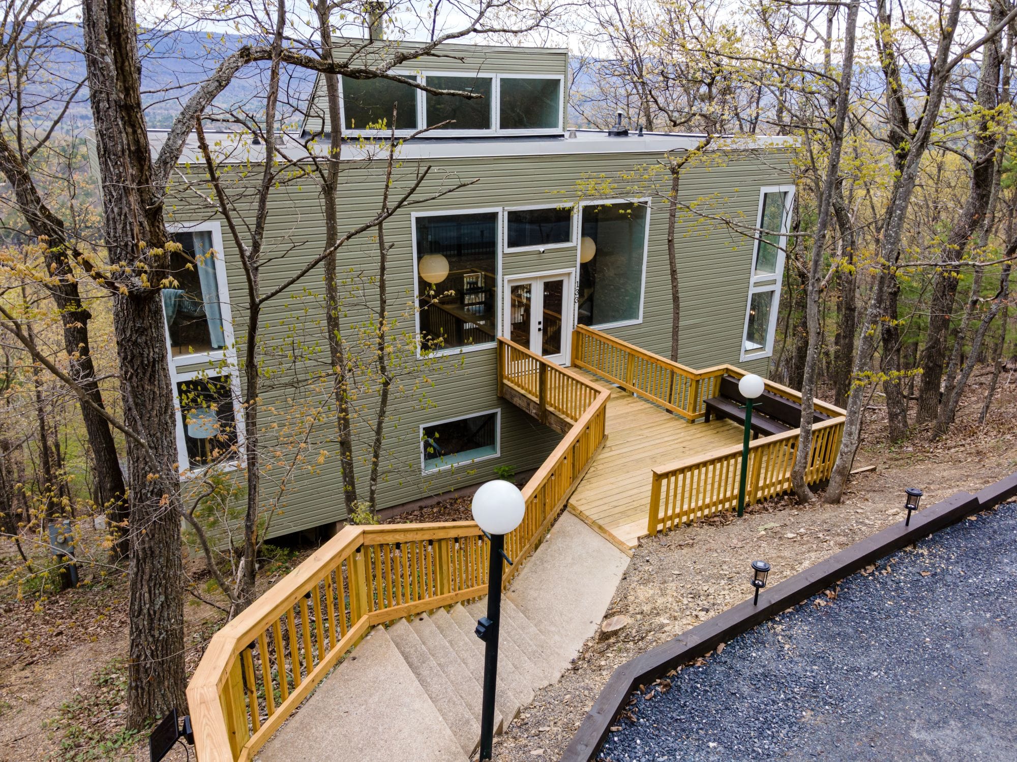 The Chalet's front deck and stairs leading up to the glass entry