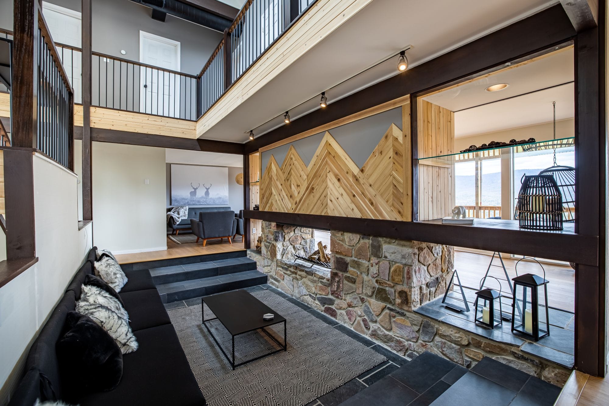 Great room lounge with the fireplace and steps up to the dining area