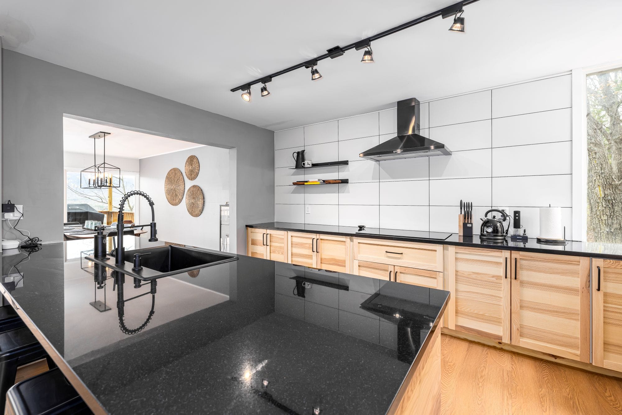Kitchen open to the dining area with a wall of storage