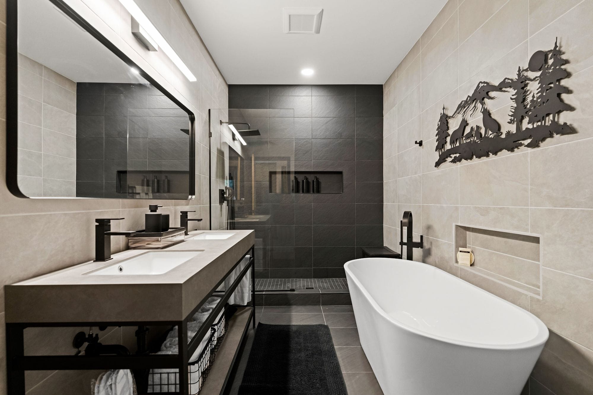 Spa bathroom with a freestanding soaking tub, walk-in glass shower, and double concrete vanity